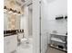 Well-lit bathroom features stylish wallpaper, shower with white and gray marble, and closet space at 3915 Corsica Pl, Wesley Chapel, FL 33543
