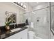 Modern bathroom with marble and gold tile, glass-enclosed shower, sleek vanity, and chic decor at 3915 Corsica Pl, Wesley Chapel, FL 33543