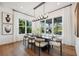 Bright dining area with large windows, modern chandelier and stylish seating at 3915 Corsica Pl, Wesley Chapel, FL 33543