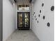 Stylish entryway featuring double doors, stone pavers, and contemporary light fixture and unique decor at 3915 Corsica Pl, Wesley Chapel, FL 33543