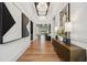 Elegant foyer featuring hardwood floors, designer lighting, and decorative accents with a glimpse of the backyard at 3915 Corsica Pl, Wesley Chapel, FL 33543
