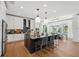 Modern kitchen with a large center island, pendant lighting, stainless steel appliances, and granite countertops at 3915 Corsica Pl, Wesley Chapel, FL 33543