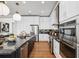 A spacious kitchen with stainless steel appliances, black granite counters and a center island with seating at 3915 Corsica Pl, Wesley Chapel, FL 33543