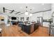 Gourmet kitchen features an island with breakfast bar, granite countertops and stainless steel appliances at 3915 Corsica Pl, Wesley Chapel, FL 33543