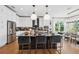 Beautiful kitchen with center island with seating, granite counters, stainless appliances, and light and bright cabinets at 3915 Corsica Pl, Wesley Chapel, FL 33543