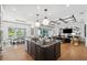 Open concept kitchen with an island with seating, modern appliances, and seamless flow to living spaces and outdoor views at 3915 Corsica Pl, Wesley Chapel, FL 33543