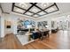 Bright living room featuring coffered ceiling, wood floors, and stylish modern furnishings at 3915 Corsica Pl, Wesley Chapel, FL 33543