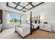 Elegant main bedroom with four-poster bed, decorative ceiling, and lots of natural light at 3915 Corsica Pl, Wesley Chapel, FL 33543