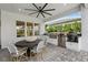 Outdoor kitchen features stainless steel grill, sink, mini fridge, and bar seating with chairs at 3915 Corsica Pl, Wesley Chapel, FL 33543
