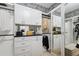 Spacious walk-in closet features custom built-in shelving, drawers, and modern black and white patterned wallpaper at 3915 Corsica Pl, Wesley Chapel, FL 33543