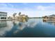 Tranquil channel view featuring waterfront homes with docks, palm trees, and open water access at 4128 Camelia Dr, Hernando Beach, FL 34607