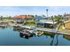 Aerial view showcases waterfront home with a private dock, boat lifts, and screened patio in a beautiful community at 4128 Camelia Dr, Hernando Beach, FL 34607