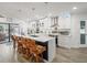 Modern kitchen with a large island, bar seating, and sleek white cabinets for ample storage at 4128 Camelia Dr, Hernando Beach, FL 34607