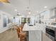 Modern kitchen with a white countertop island, stainless steel appliances, and adjacent dining area at 4128 Camelia Dr, Hernando Beach, FL 34607