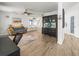 Inviting living room features stylish decor, wood-look tile flooring, and a charming built-in cabinet for display at 4128 Camelia Dr, Hernando Beach, FL 34607