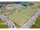 Aerial view showcasing multi-purpose fields, and baseball field plus surrounding neighborhood at 4188 Barbour Trl, Odessa, FL 33556