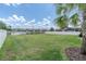 Beautifully maintained backyard with a view of a serene pond and a white fence at 4188 Barbour Trl, Odessa, FL 33556