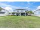 Spacious backyard featuring a covered patio and a well-maintained lawn with a privacy fence at 4188 Barbour Trl, Odessa, FL 33556