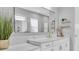Modern bathroom with dual sink vanity, white marble counters, and a large decorative mirror at 4188 Barbour Trl, Odessa, FL 33556