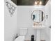 Stylish powder room with modern fixtures, patterned wallpaper, and a pedestal sink at 4188 Barbour Trl, Odessa, FL 33556