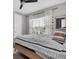 Cozy bedroom with a window, wood floors, and modern decor at 4188 Barbour Trl, Odessa, FL 33556