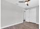This spacious bedroom features wood flooring, fresh paint, and a ceiling fan at 4188 Barbour Trl, Odessa, FL 33556