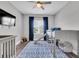 Comfortable bedroom with a playful bunk bed, large window, and stylish blue accents at 4188 Barbour Trl, Odessa, FL 33556