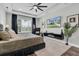 This spacious bedroom features dark wood floors, a large ceiling fan, and a mounted television at 4188 Barbour Trl, Odessa, FL 33556