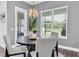 Cozy dining area with a round table, stylish chairs, modern light fixture, and backyard views at 4188 Barbour Trl, Odessa, FL 33556