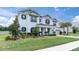Charming two-story home with black trim, a brick driveway and professionally landscaped front yard at 4188 Barbour Trl, Odessa, FL 33556