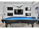 Stylish game room featuring a pool table and multiple TV screens for ultimate entertainment at 4188 Barbour Trl, Odessa, FL 33556
