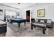 Spacious game room featuring a pool table, air hockey table, comfortable seating, and adjacent home theater at 4188 Barbour Trl, Odessa, FL 33556