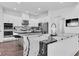 Modern kitchen with white cabinets, stainless steel appliances, and a marble island countertop at 4188 Barbour Trl, Odessa, FL 33556
