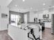 Open kitchen featuring a marble island, modern appliances, and elegant lighting at 4188 Barbour Trl, Odessa, FL 33556