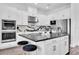 Modern kitchen boasts white cabinets, stainless appliances, an island, and stylish black countertops at 4188 Barbour Trl, Odessa, FL 33556