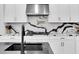Bright kitchen with white cabinetry, black and white countertops, and stainless steel appliances at 4188 Barbour Trl, Odessa, FL 33556
