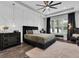 The main bedroom features decorative walls, dark wood floors, and a large bright window at 4188 Barbour Trl, Odessa, FL 33556