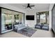 Screened patio with a ceiling fan and stylish furniture at 4188 Barbour Trl, Odessa, FL 33556