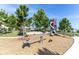 Community playground featuring see-saw, tube slide, and climbing structure on a mulch groundcover base at 4188 Barbour Trl, Odessa, FL 33556