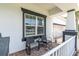Charming front porch with seating area and brick flooring at 4188 Barbour Trl, Odessa, FL 33556