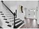 Bright staircase with white risers and black stairs leading to the second floor at 4188 Barbour Trl, Odessa, FL 33556