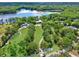 Expansive lakefront estate with a charming home, lush greenery, and access to a serene lake at 4541 School Rd, Land O Lakes, FL 34638