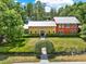 Stunning aerial view of a colorful home surrounded by lush greenery and picturesque landscaping at 4541 School Rd, Land O Lakes, FL 34638
