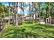The spacious backyard boasts lush greenery, mature trees, a private pool, and room to play at 4541 School Rd, Land O Lakes, FL 34638