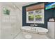 Well-lit bathroom with a soaking tub, separate shower, and a modern vanity at 4541 School Rd, Land O Lakes, FL 34638