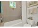 Clean bathroom with a combined tub and shower and decorative accents at 4541 School Rd, Land O Lakes, FL 34638