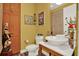 Charming half bathroom with unique decor, a vessel sink, and a quirky, colorful design at 4541 School Rd, Land O Lakes, FL 34638