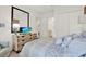 Bright bedroom with a large mirror, dresser, and a peek into the adjacent bathroom at 4541 School Rd, Land O Lakes, FL 34638