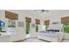 Light and airy bedroom with a white bed, nautical decor, and multiple windows for lots of sunlight at 4541 School Rd, Land O Lakes, FL 34638