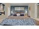 Comfortable bedroom with a ceiling fan, a striking accent wall and wood-look flooring at 4541 School Rd, Land O Lakes, FL 34638